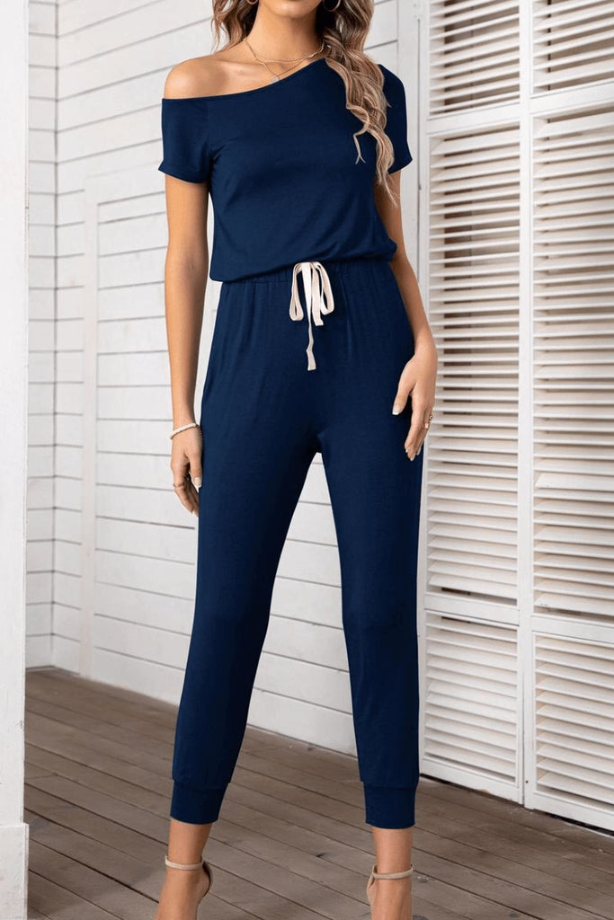 Blue jumpsuit with asymmetrical neckline